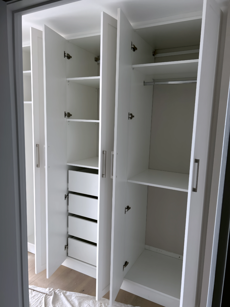 deep walk-in closet with full-height mirror