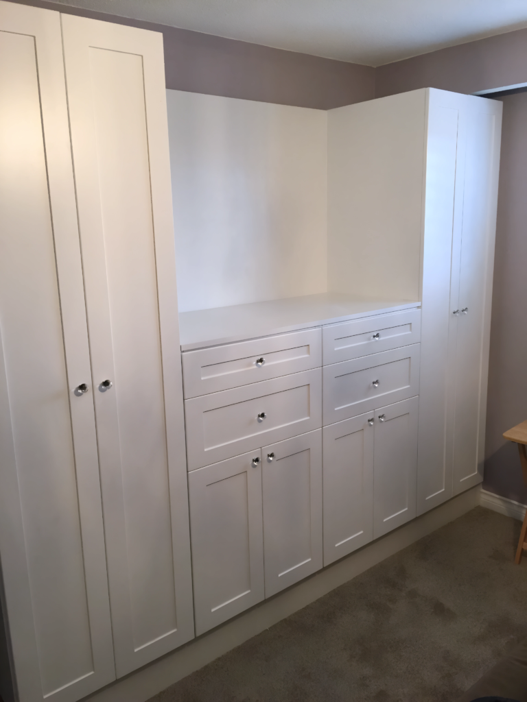 hidden closet door with bookcase cabinetry