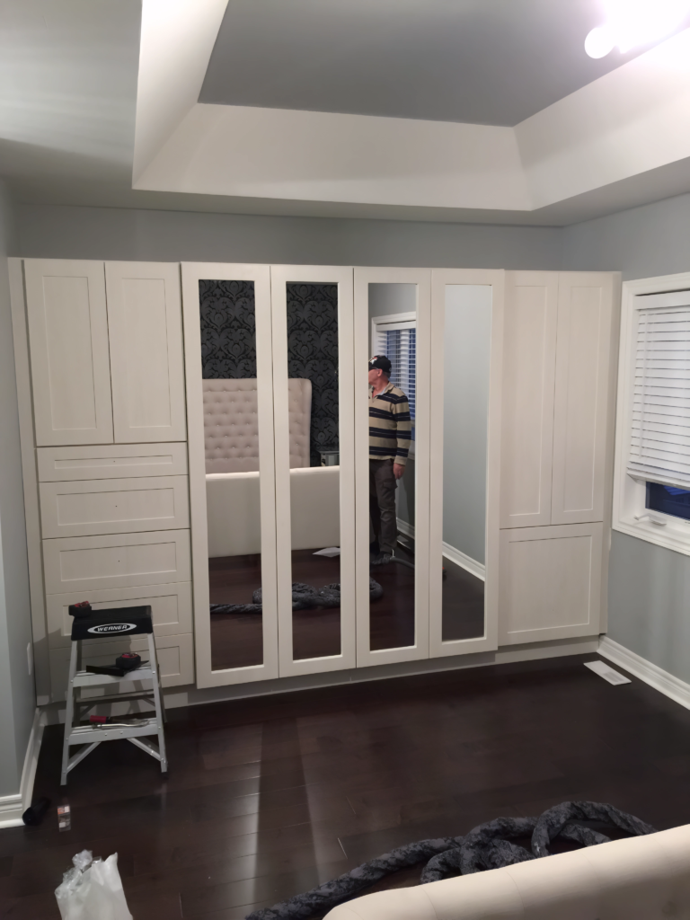 wall-to-wall built-in wardrobe with mirror panels