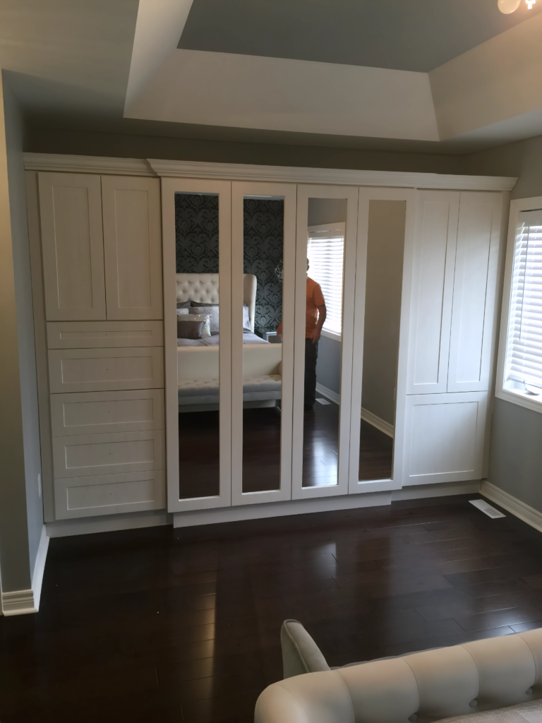 Toronto condo closet with hanging rods and shelves