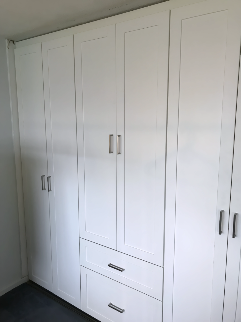 functional closet island with drawers and hangers
