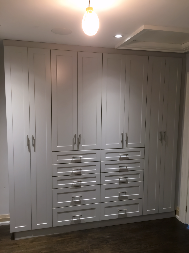 dark wood closet design with brass handles
